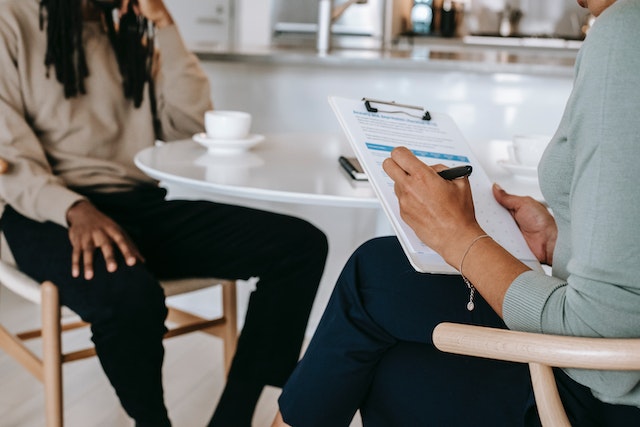 interview with person jotting down stuff on clipboard